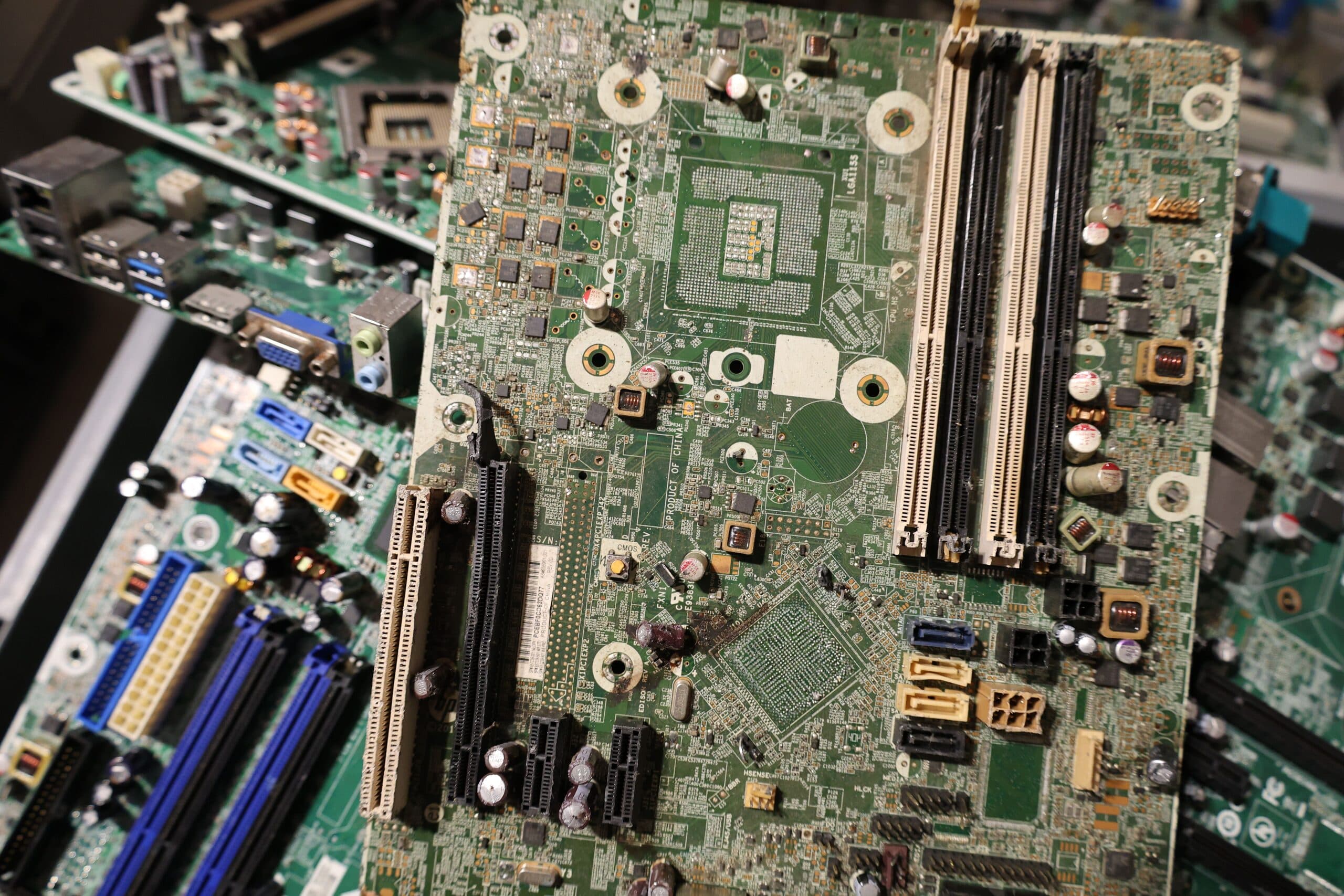 A pile of retired circuit boards in greens, reds, and blues